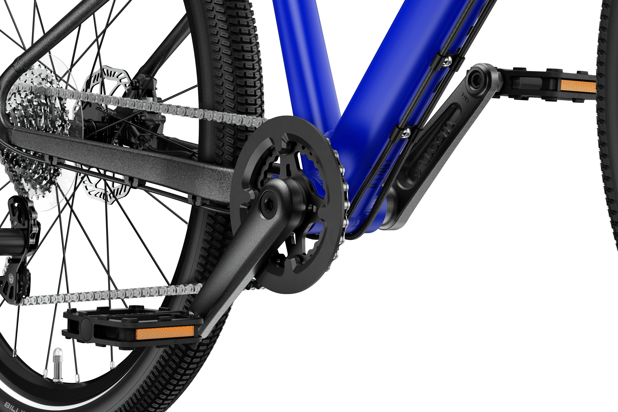 Detaljeret billede af pedal og pedalarm på en woom EXPLORE 4 børnecykel.