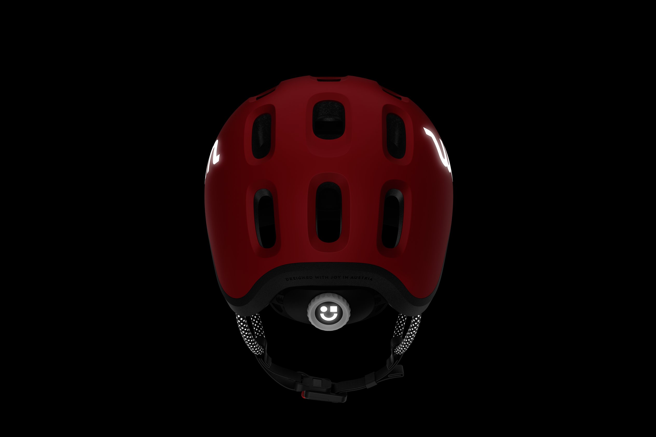 Side view of the READY Kids' Helmet with the reflective woom logos and straps in the dark