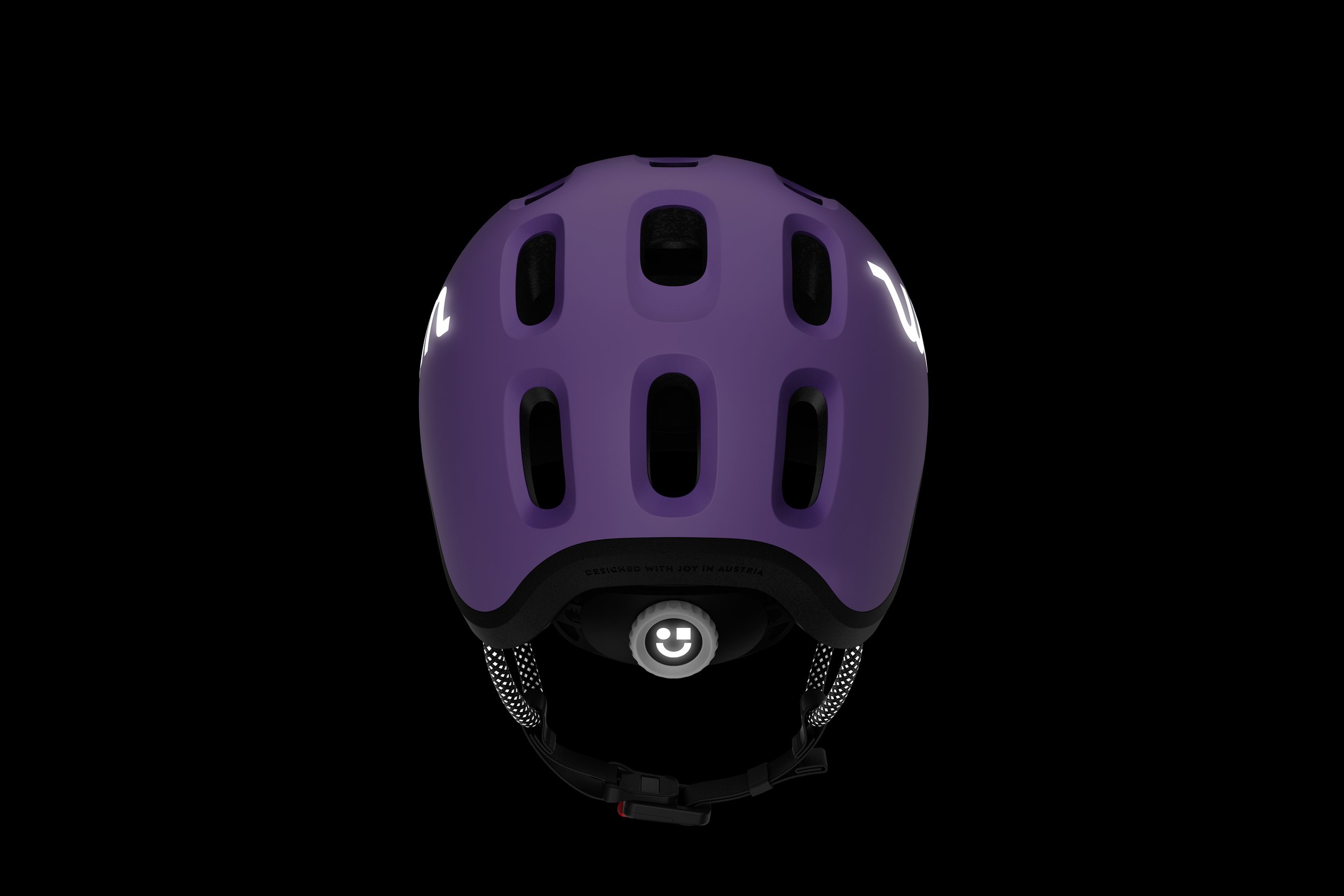 Side view of the READY Kids' Helmet with the reflective woom logos and straps in the dark