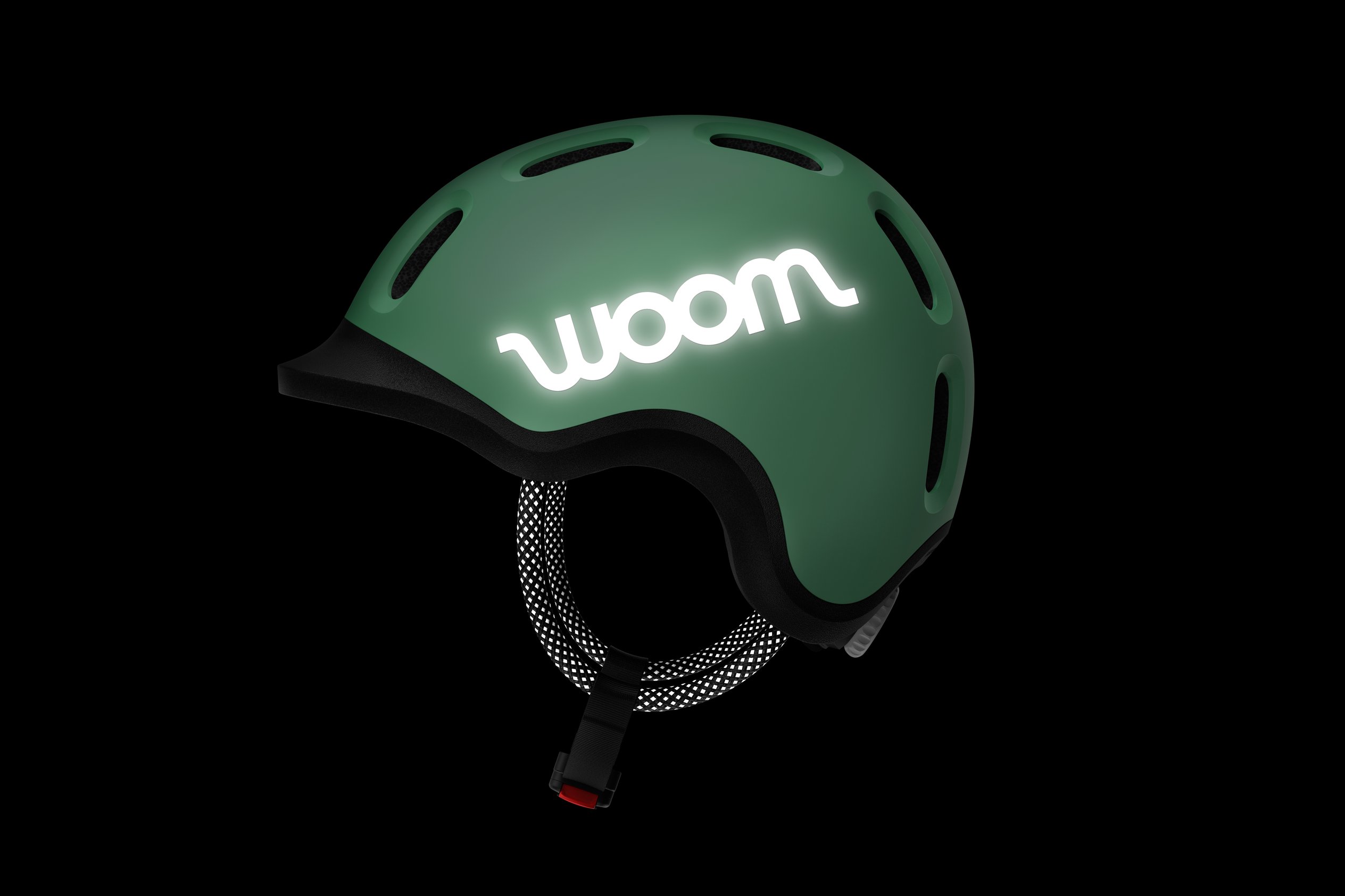 Donker zijaanzicht van de READY-kinderhelm met reflecterende woom-sticker en koordjes