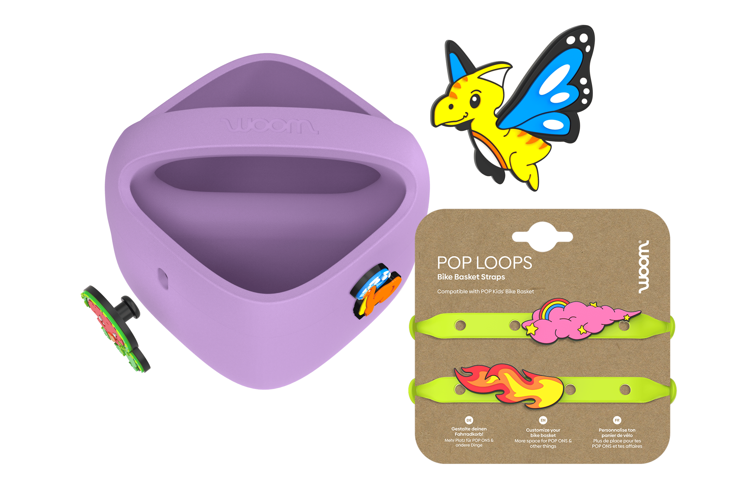 Lila woom POP Fahrradkorb mit POP ONS neben neongrünen POP LOOPS auf Karton und einem neuen Flugsaurier-POP ON darüber