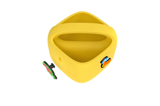 Purple woom POP Kids' Bike Basket with a POP ON charm being pushed into an opening on the side.