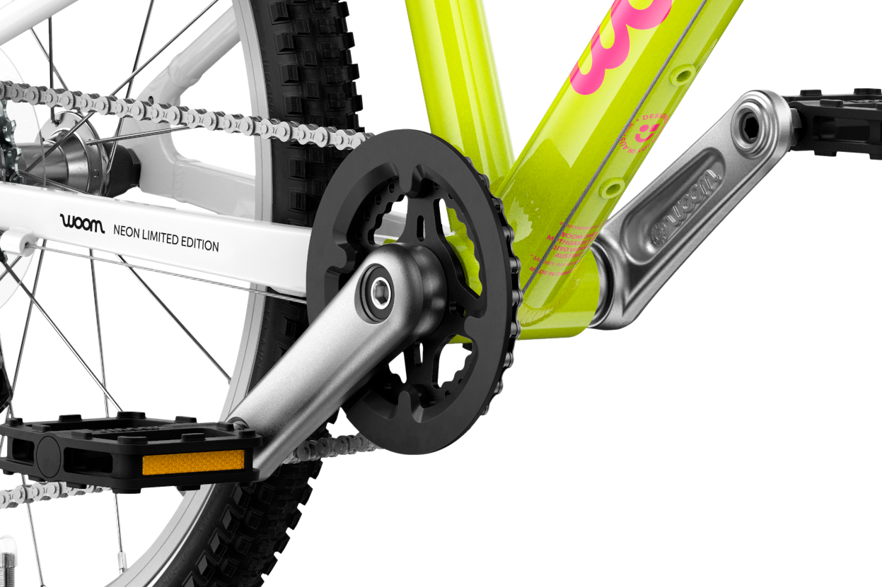 Detailed view of the cranks and pedals on the woom GO 4 children's bike