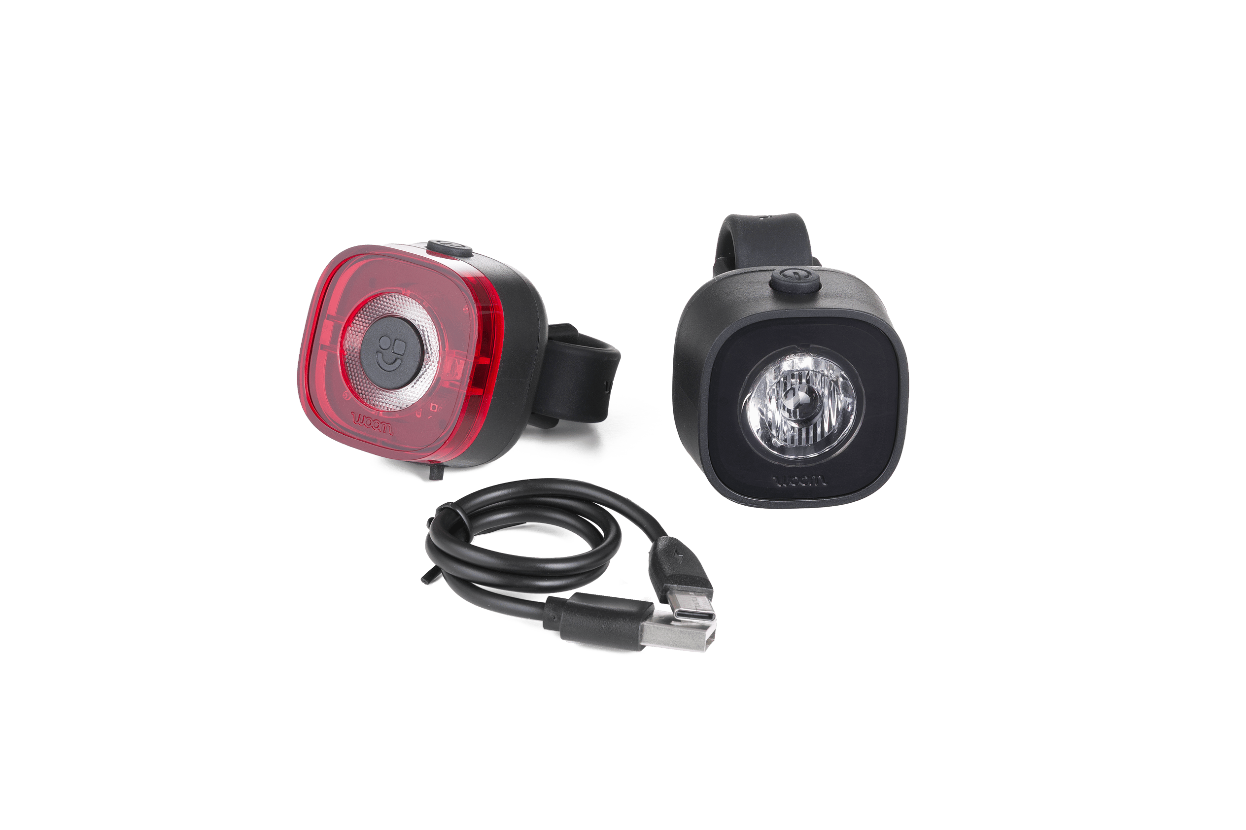 woom BEAM kids bike light set with front white light, rear red light, and USB charging cable.