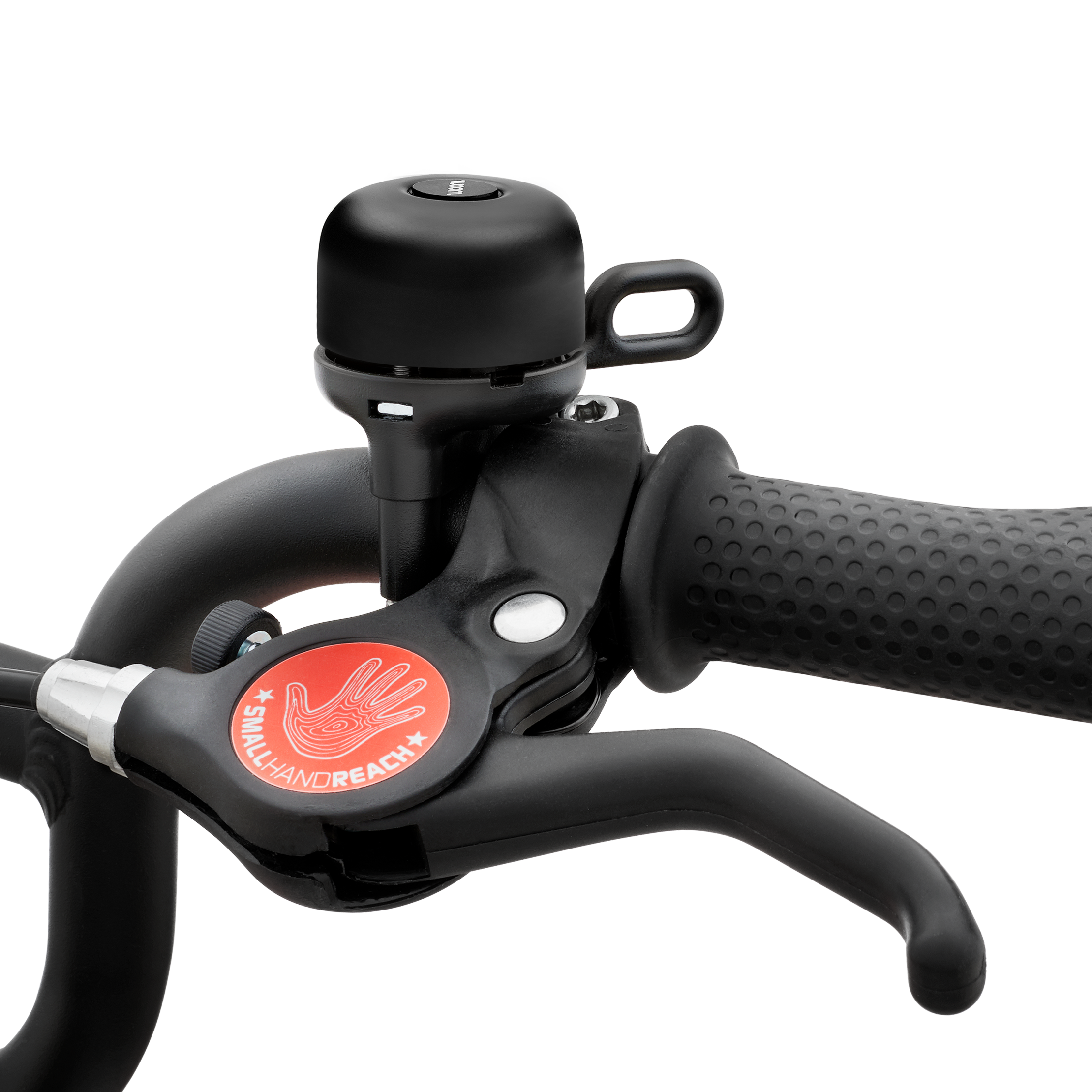 Sonnette de vélo BING noire montée sur le guidon d'un woom bike.