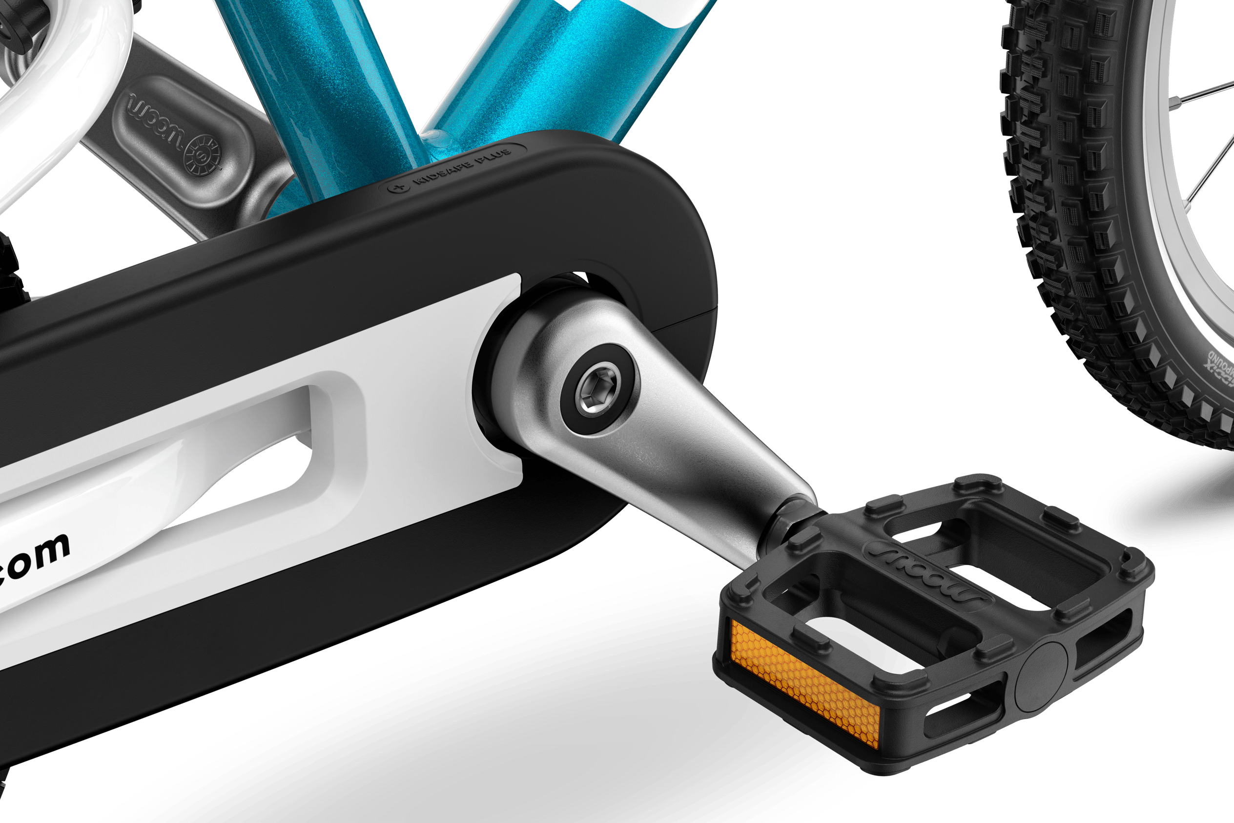Detailed view of the pedals, cranks and chainguard on the woom GO 2 children's bike