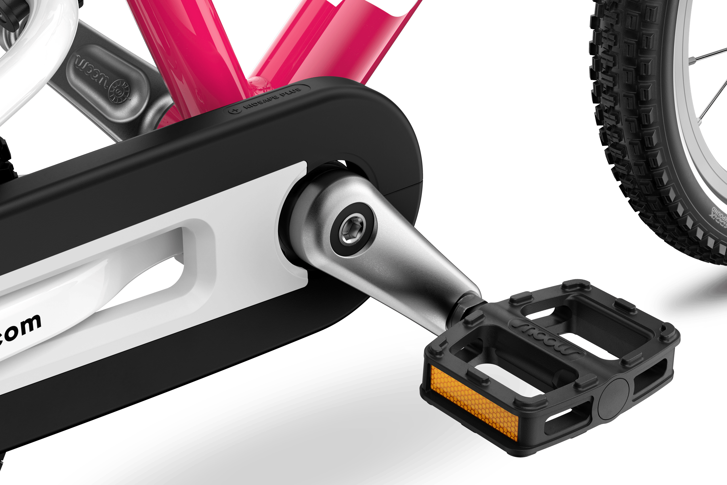 Detailed view of the pedals, cranks and chainguard on the woom GO 2 children's bike