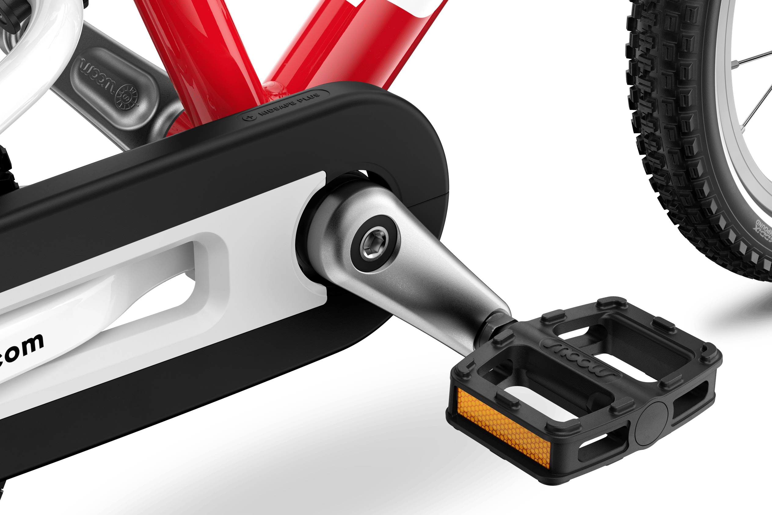 Detailed view of the pedals, cranks and chainguard on the woom GO 2 children's bike