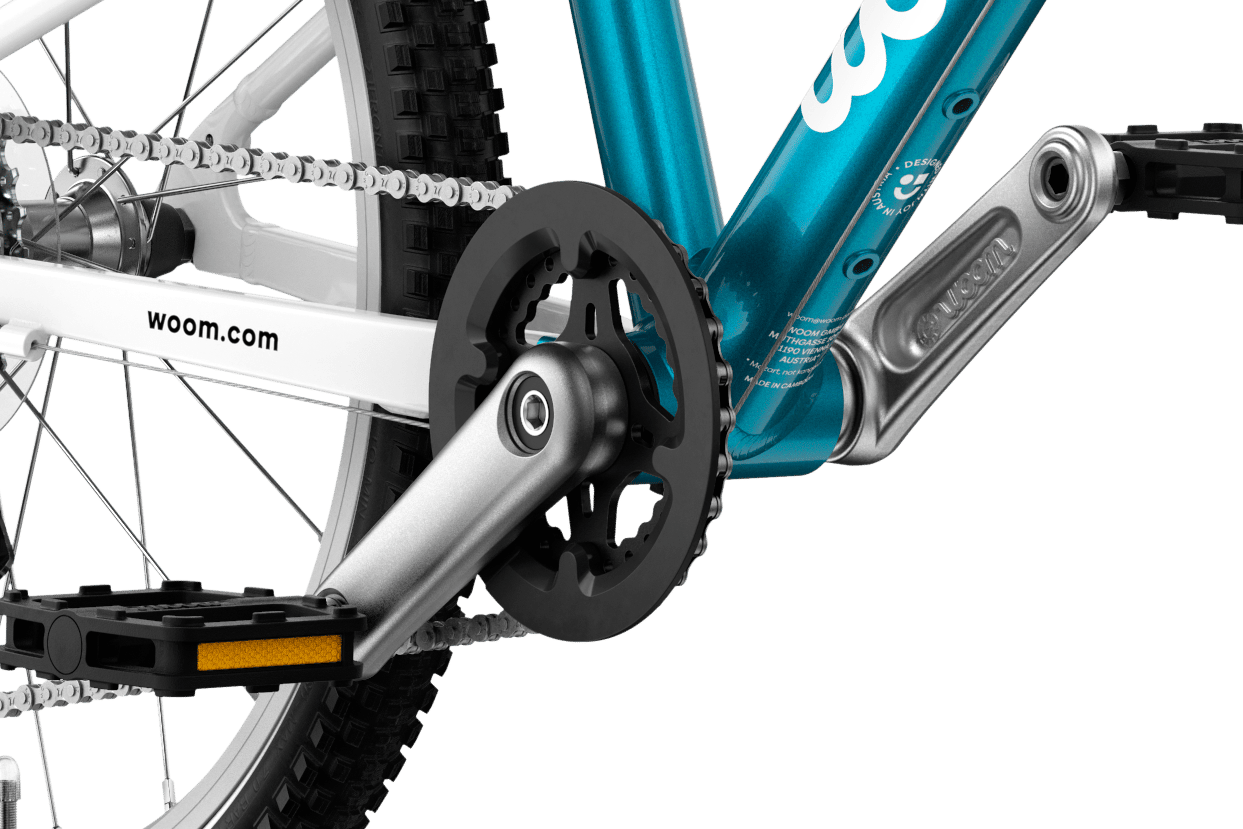Detailed view of the cranks and pedals on the woom GO 4 children's bike