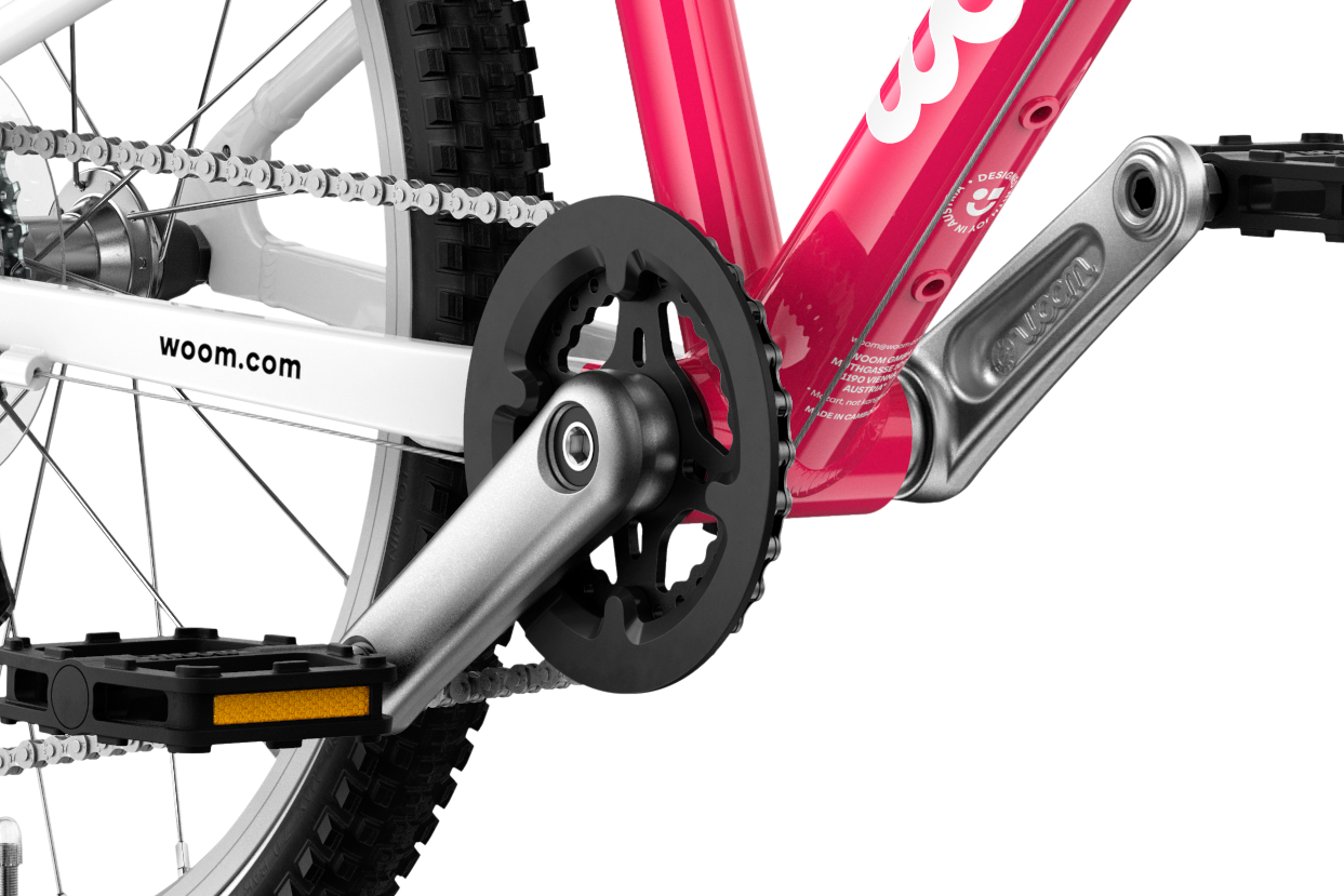 Detailed view of the cranks and pedals on the woom GO 4 children's bike