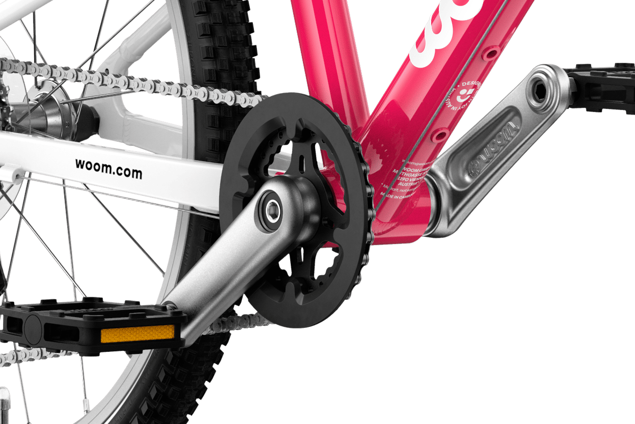 Detailed view of the cranks and pedals on the woom GO 4 children's bike
