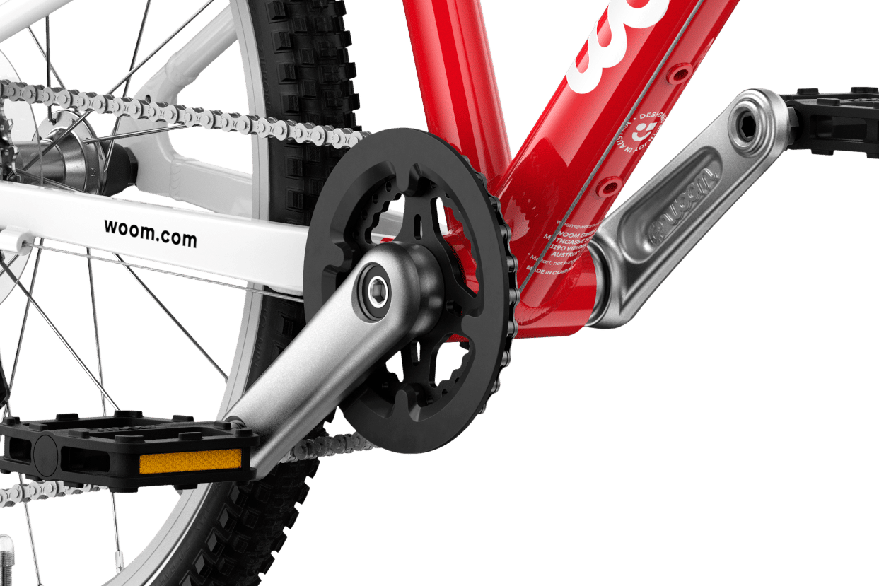 Detailed view of the cranks and pedals on the woom GO 4 children's bike