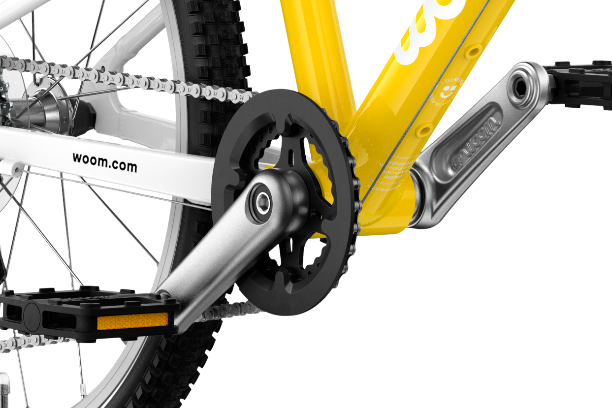 Detailed view of the cranks and pedals on the woom GO 4 children's bike